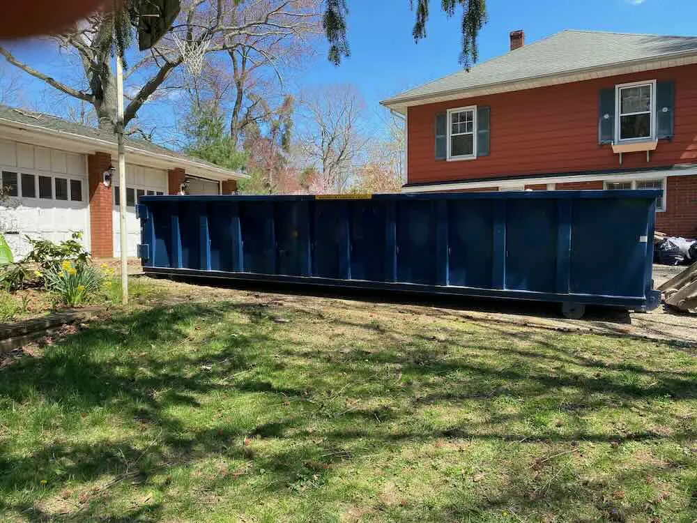 2 dumpster in front of garage