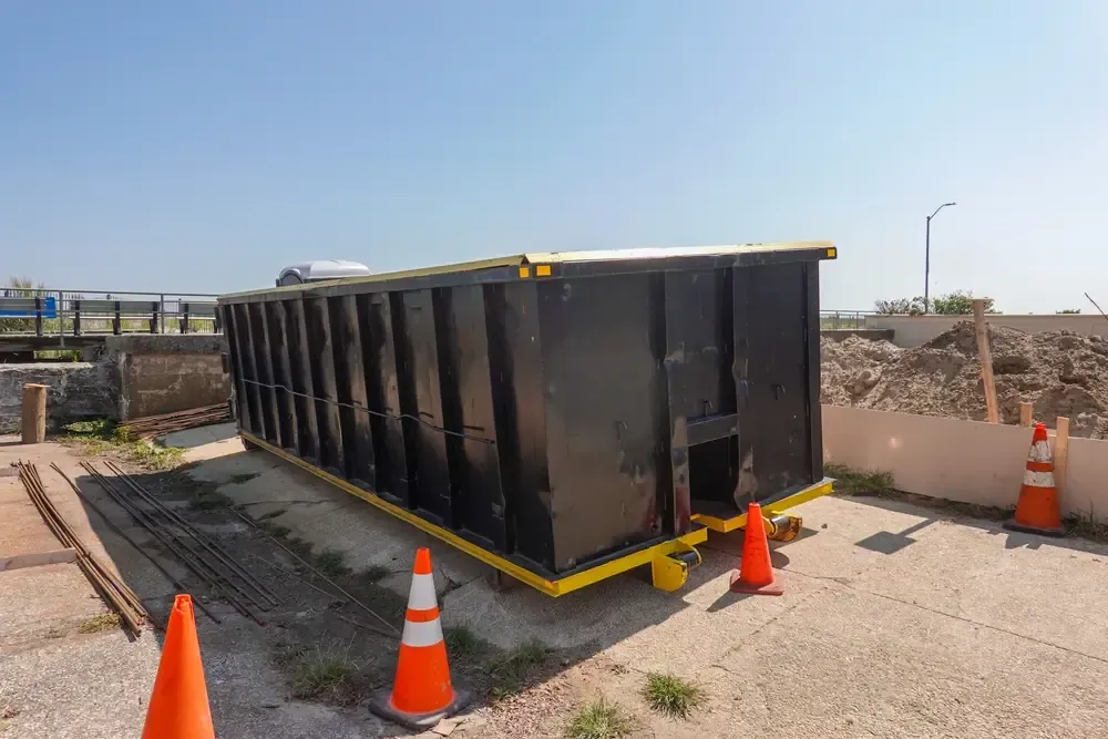 Dumpster with construction cones near