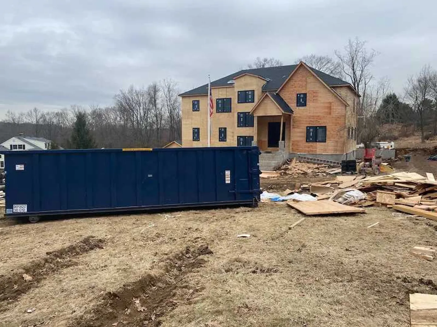 image of a roll off bin on job site 