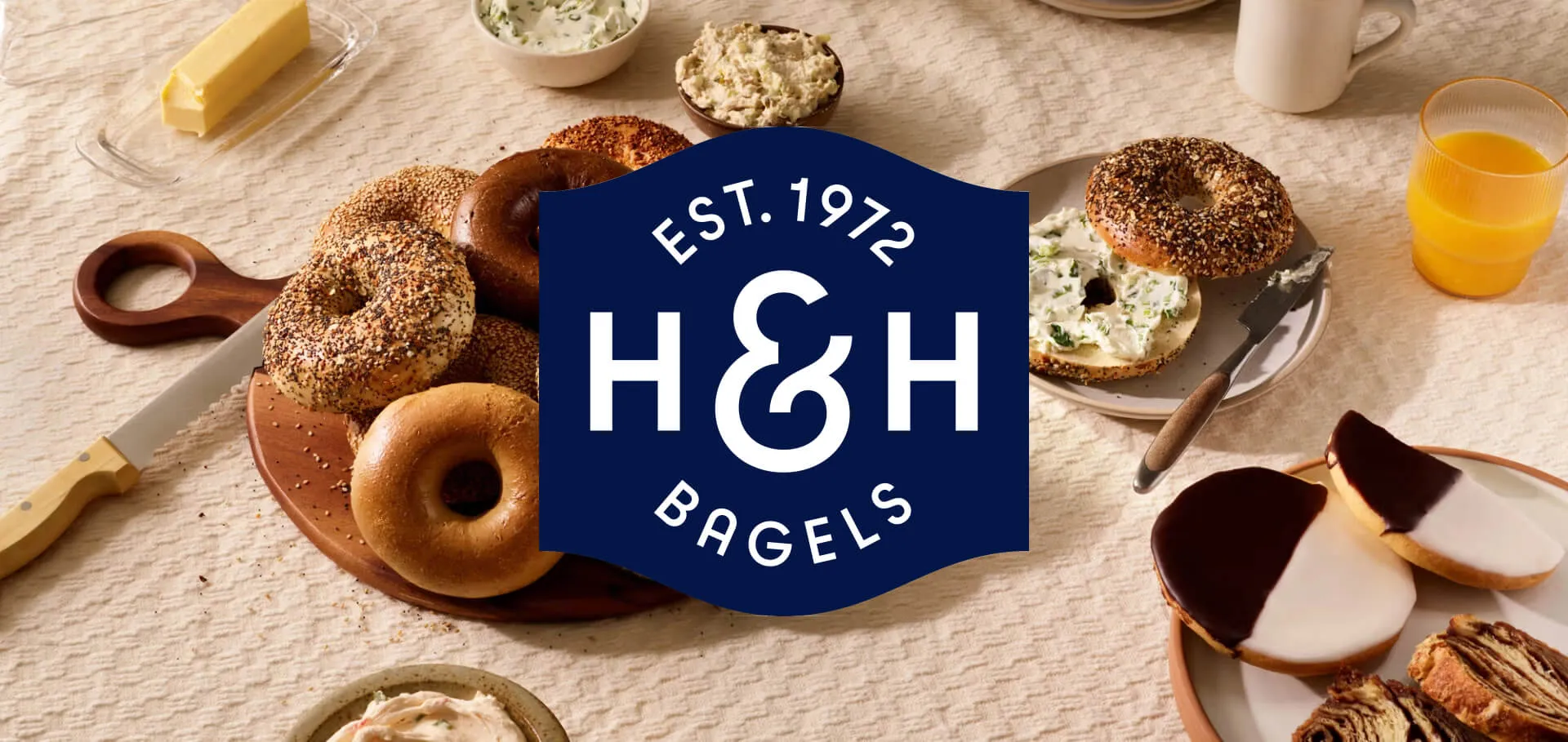 H&H Bagels Logo on backdrop of bagels