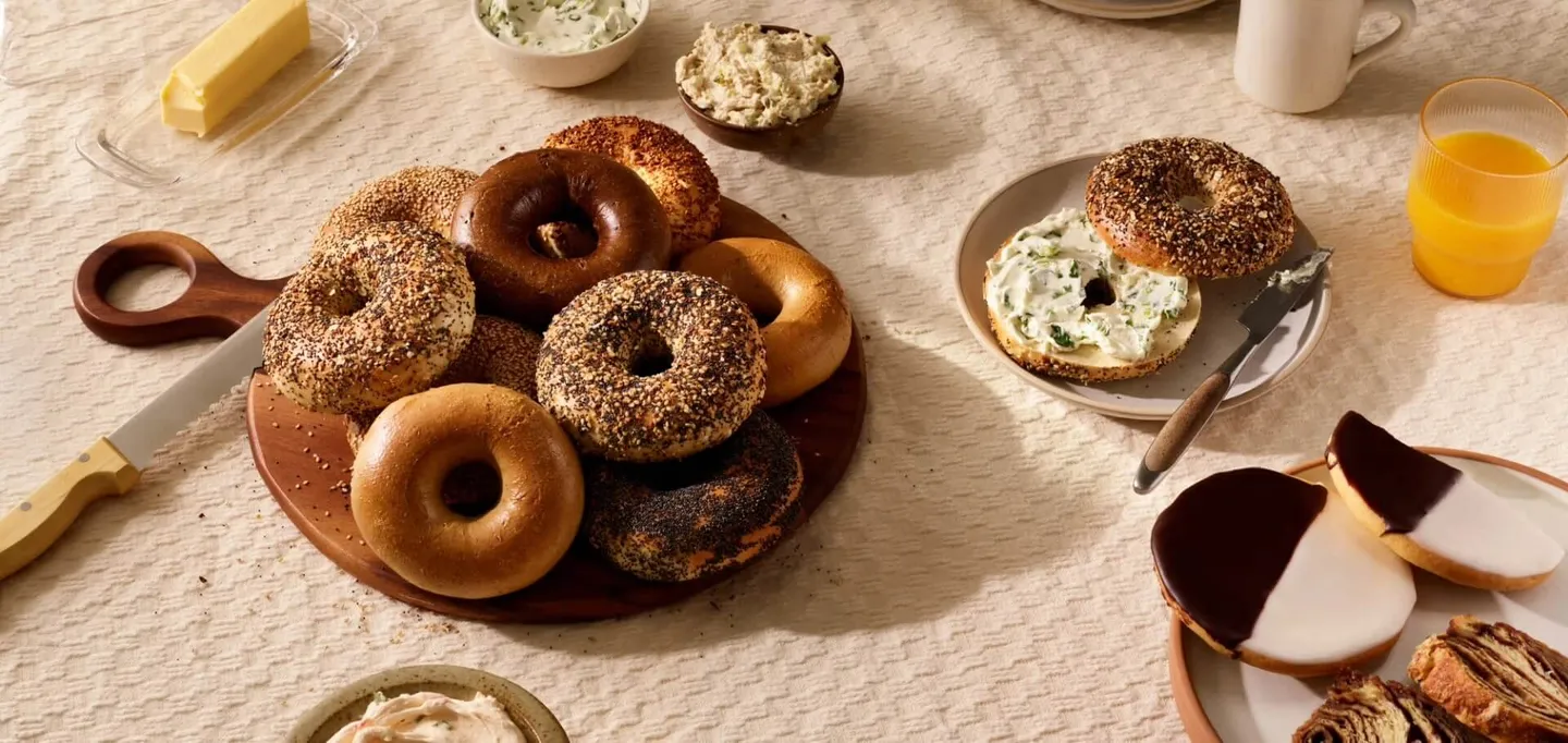 Bagels and pastries spread out on a table