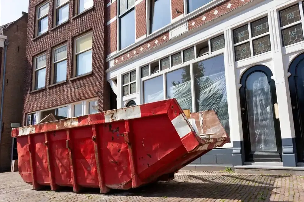 Red dumpster in front of building