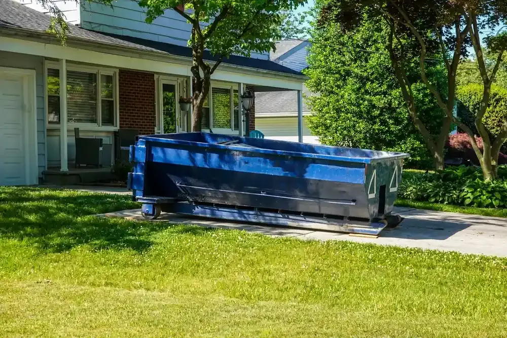 Blue dumpster in driveway