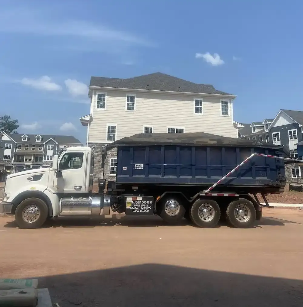 truck filled with wood in front of house