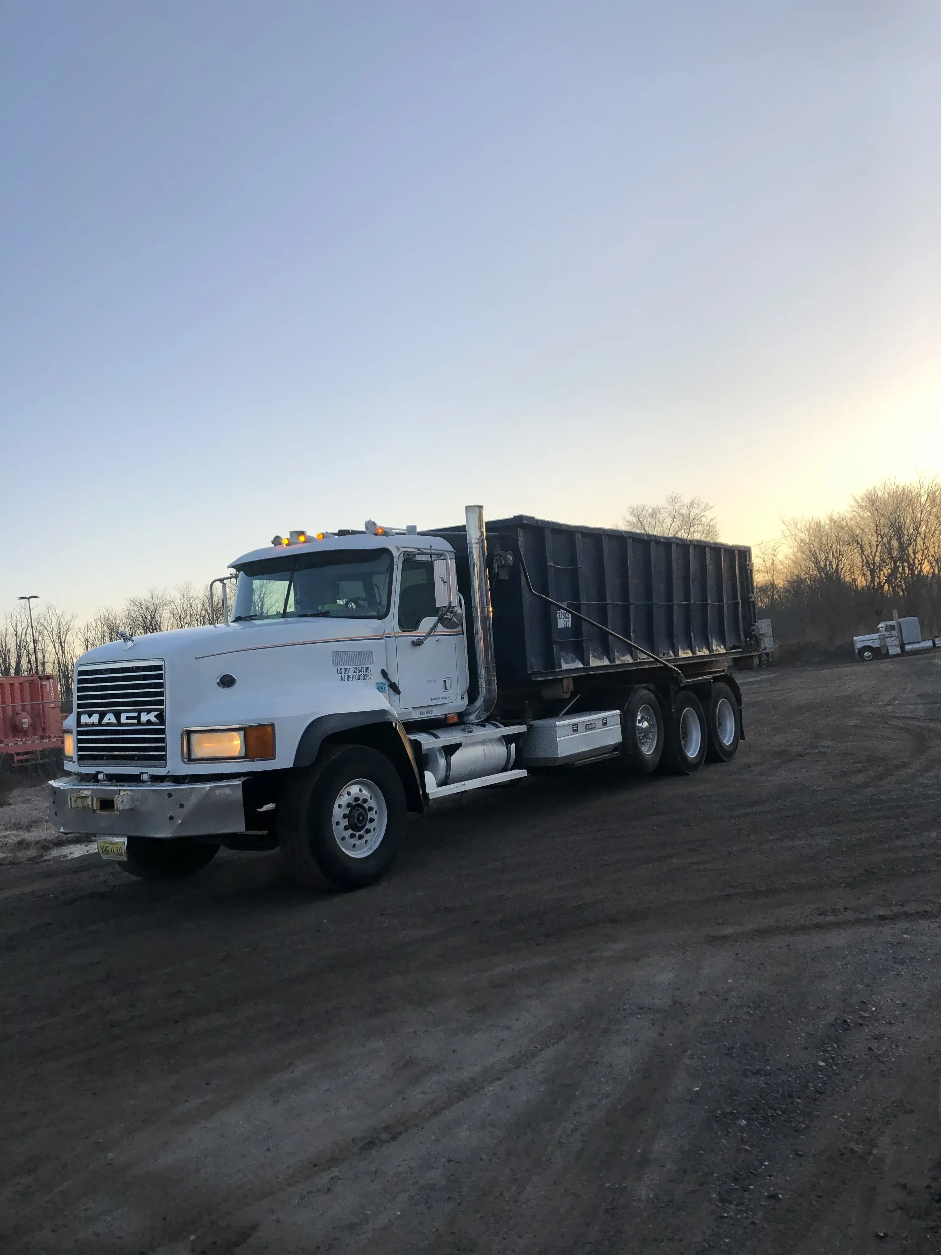 truck on job site with sunset